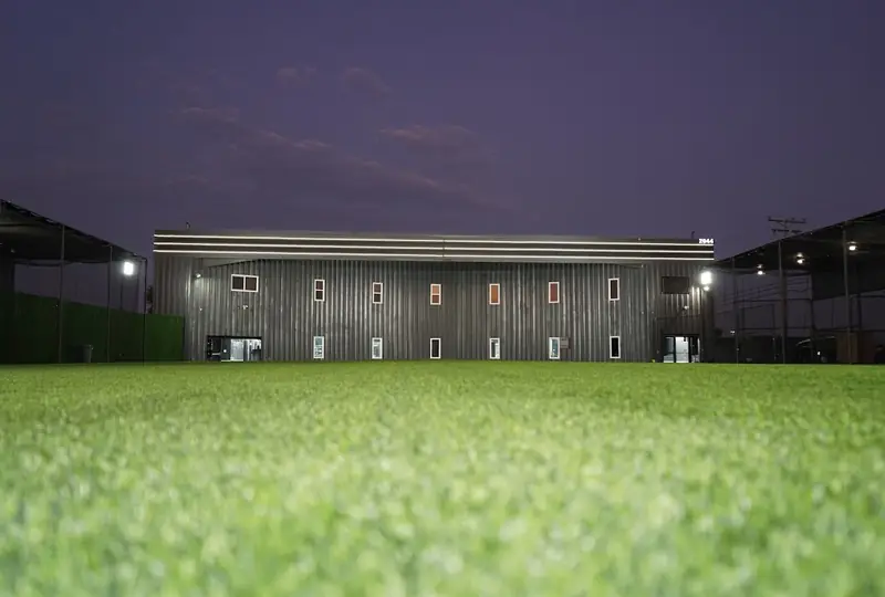 The outdoor field at MF Training SB lit at dusk