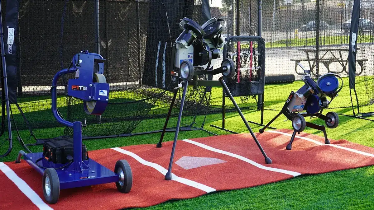 Pitching machines set up inside a batting cage at MF Training SB
